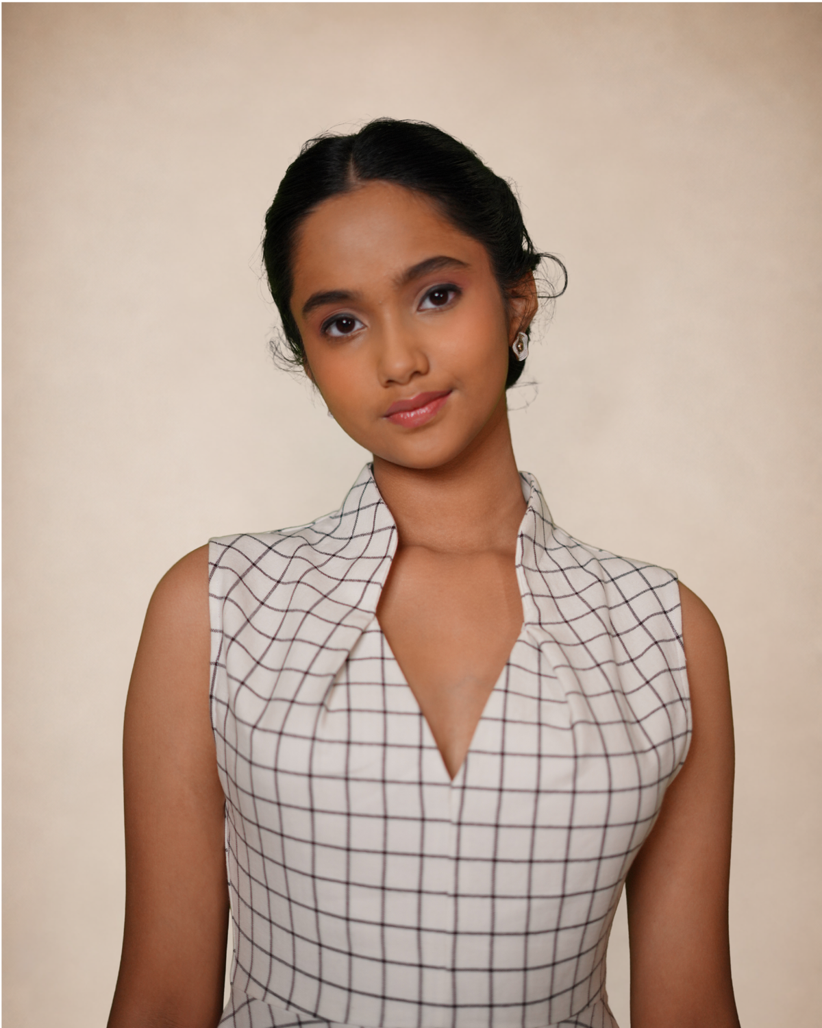 sleeveless white top with a black grid pattern and a notched collar