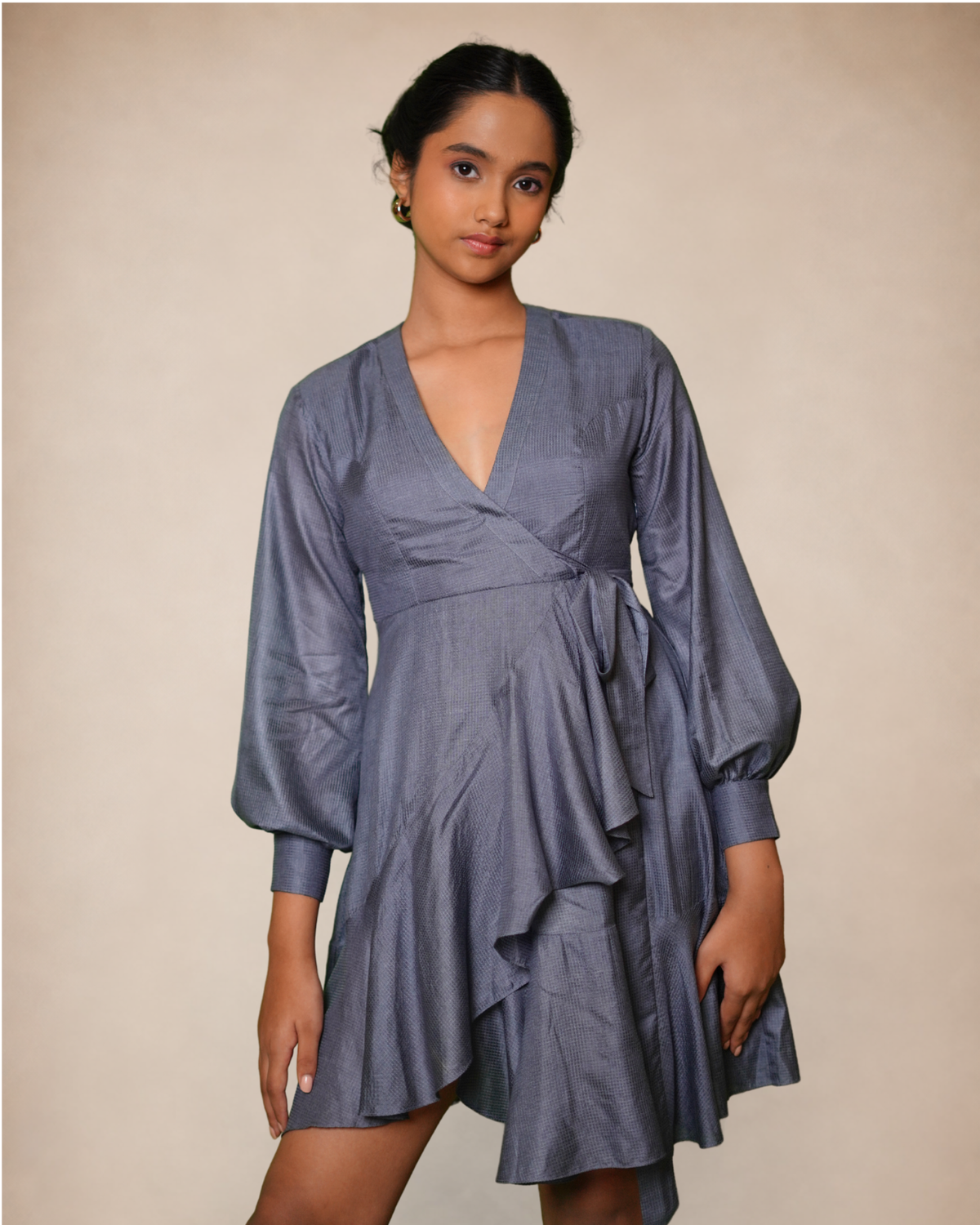 a slate blue wrap dress with balloon sleeves and a ruffled skirt