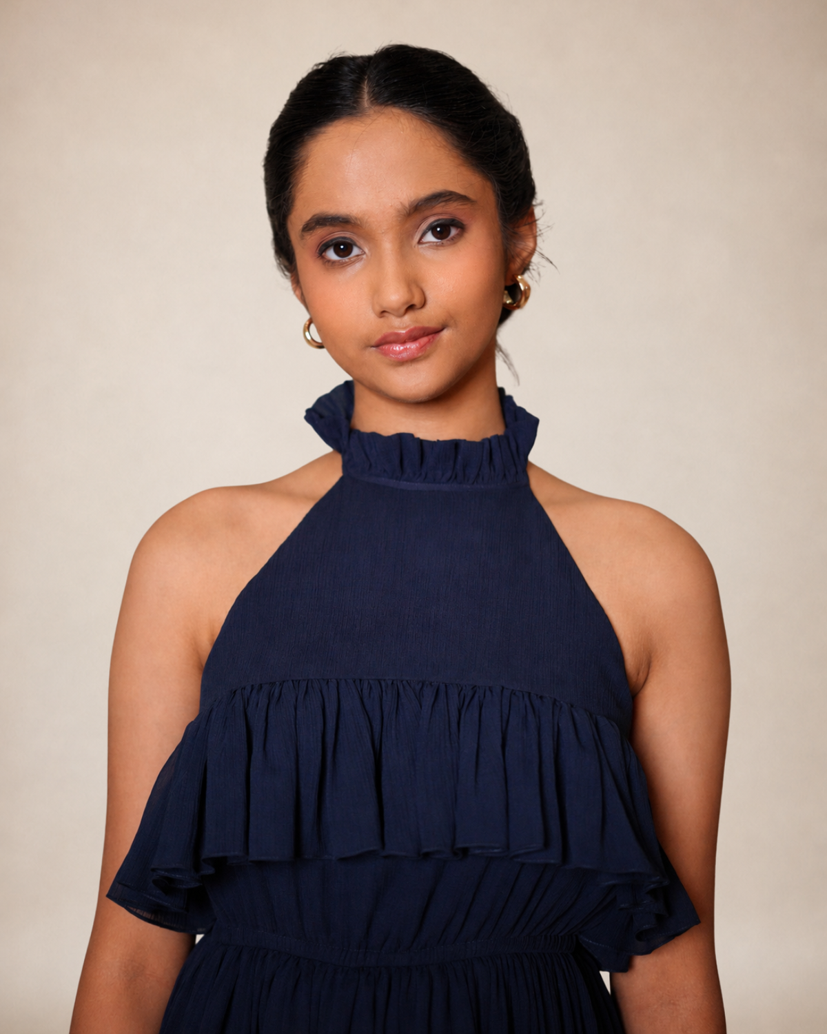 Navy blue halter neck dress with ruffle detail and flowy tiered skirt