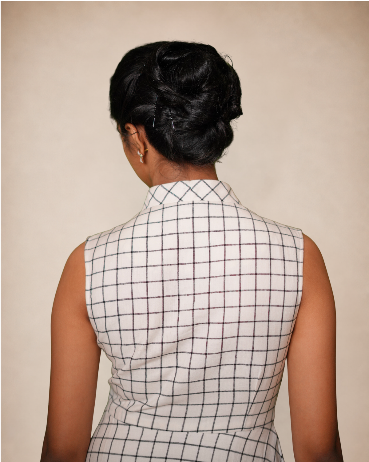 sleeveless white top with a black windowpane grid pattern